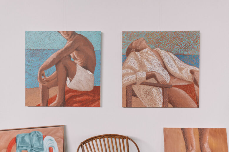 Laura Lois surrounded by paintings in her studio, wearing Collective Gen overalls